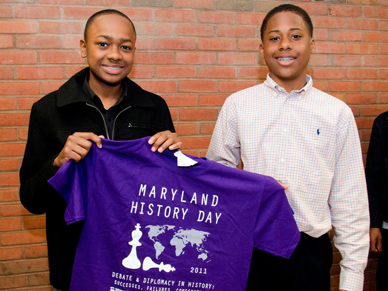 Maryland History Day Boys Holding Shirt