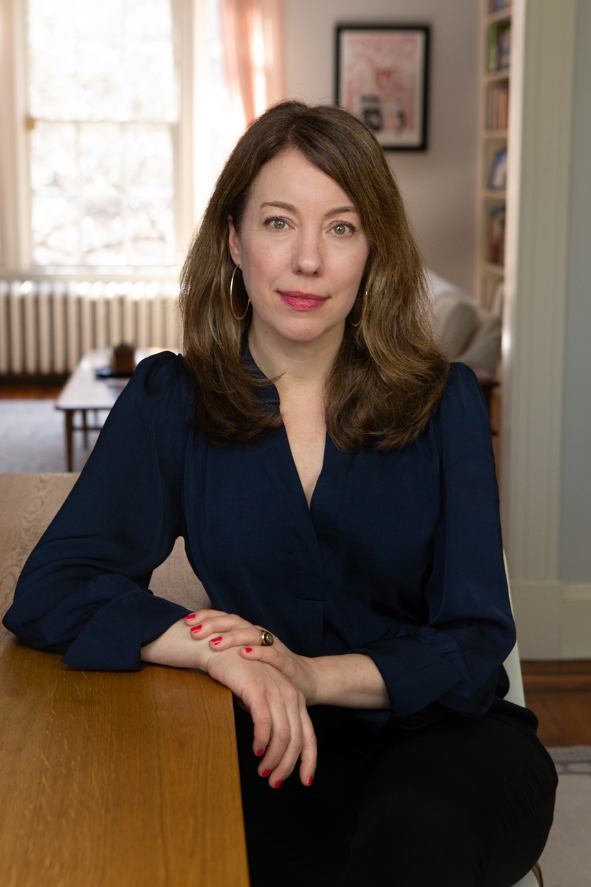 Headshot of author, Elizabeth Evitts Dickinson, seated at table.