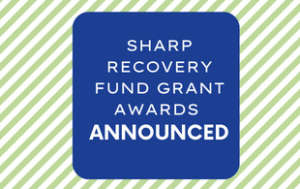 Text that says "SHARP Recovery Fund Grant Awards Announced." The text is white and in a royal blue box. The box sits on a background of white and light green stripes.
