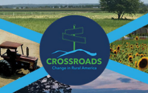 A college of 4 photos. In the middle, there is a navy blue circle that has an outline of a green signpost with two signs with now words on them. Underneath it, it says in green capital letters "Crossroads." In light blue it says "Change in Rural America." The 4 images are a field of sunflowers, a sky and tree, a tractor, and a field with a tree and mountains in the background.