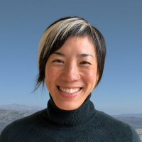image (1) Image of Susan Liao, an asian woman with short hair with a light blonde streak and a black turtlleneck.